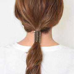 SISYOUP worn in curly ponytail demonstrating secure hold and no-crease finish