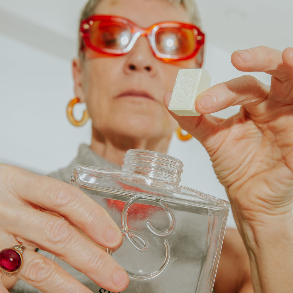 Skipper bottle in hand showing compact refill size and convenience