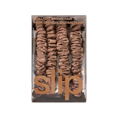 SLIP scrunchie near silk pillow suggesting overnight protection and less breakage