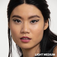 Smashbox model outdoors with dewy skin demonstrating sun protection and radiance benefit