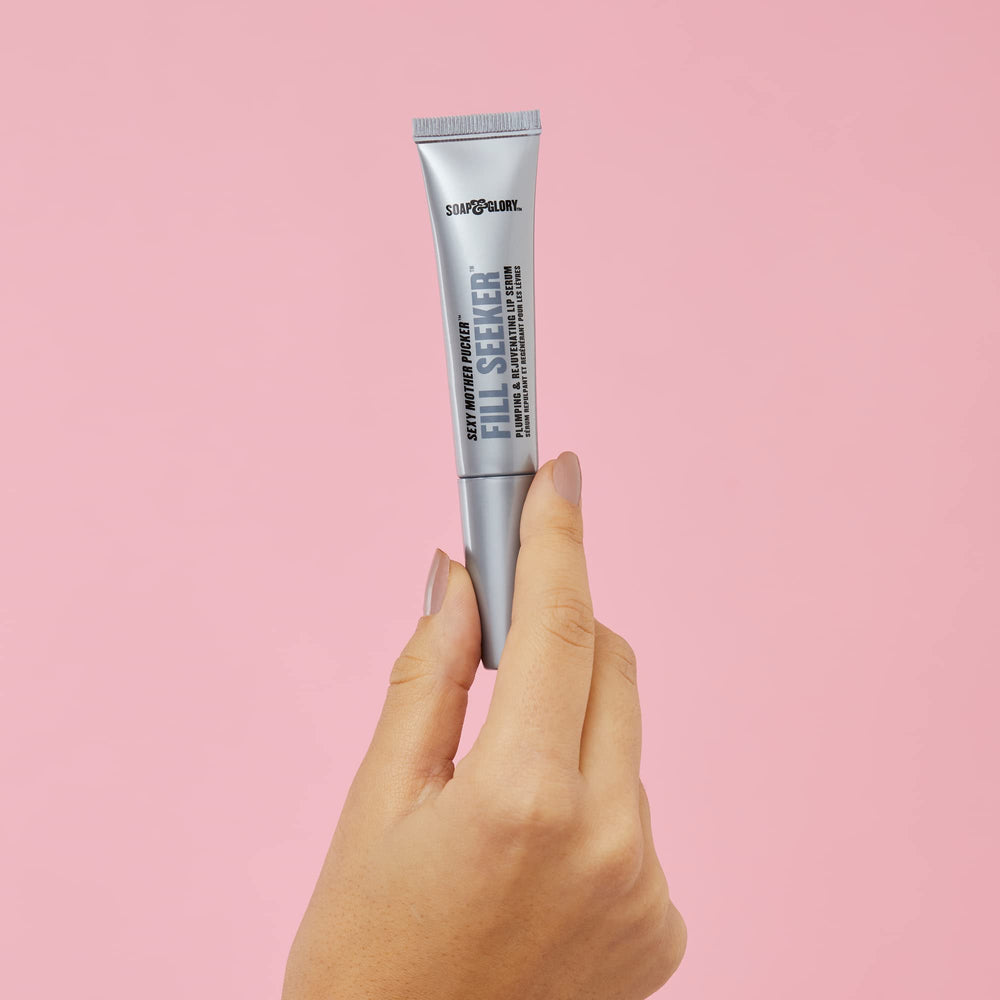 Soap & Glory gloss held in hand for scale showing compact travel size benefit