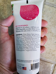 Child applying SoCozy cream to curls demonstrates gentle styling and frizz control benefit