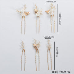 SOLENY pins held between fingers for scale showing lightweight size and easy placement