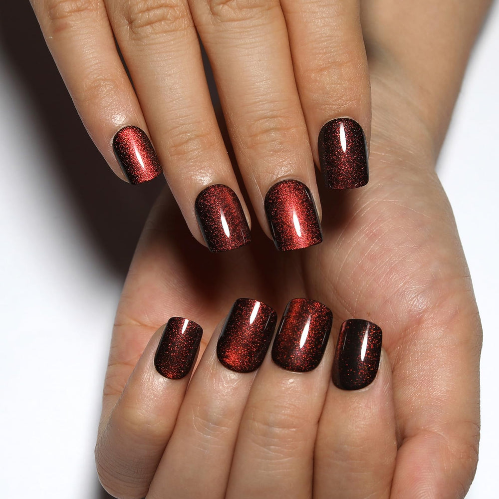 Stbisen close-up of cat eye stripe on wine red nail, striking color shift