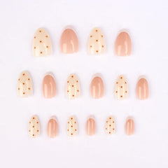 Stbisen close-up of white French tip and brown dot detail highlighting modern design