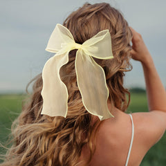 STSTR bow styled on a bun showing elegant silhouette benefit: formal-ready finish