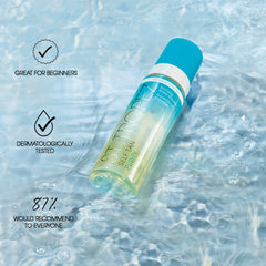 St.Tropez bottle held in hand to show travel-friendly size
