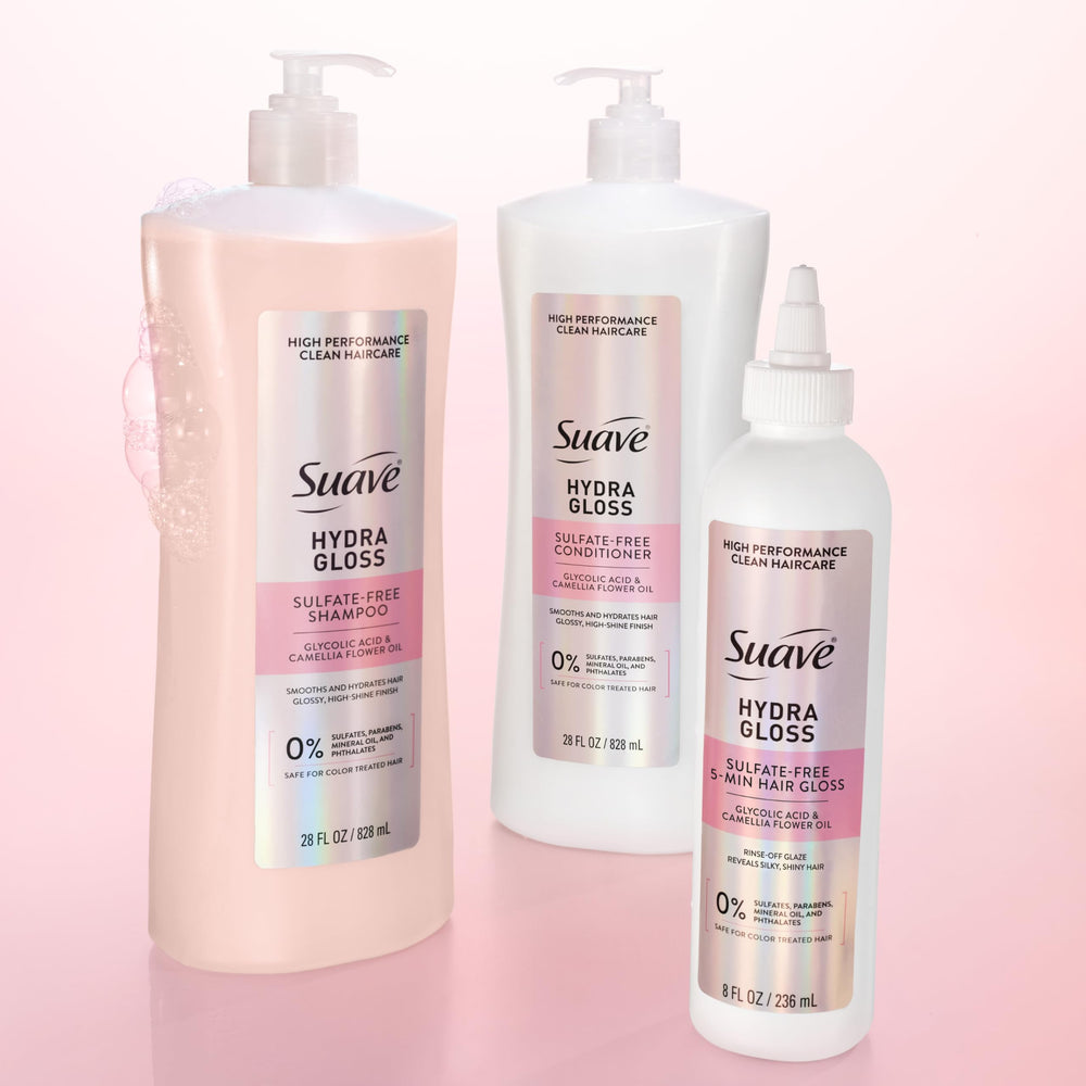 Suave bottles next to hand for scale showing full-size 28 oz value