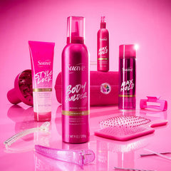 Stylist using Suave hairspray in front of mirror demonstrating on‑the‑go styling benefit