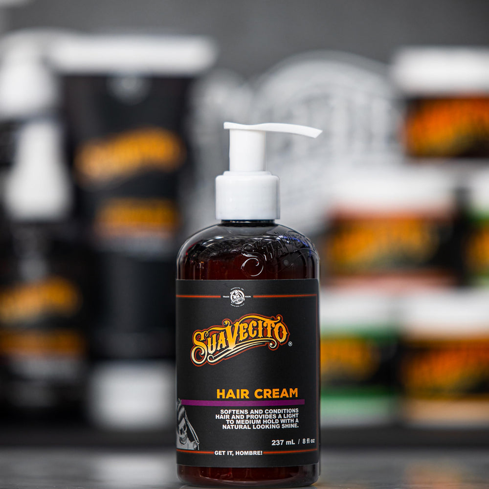 Suavecito in barbershop setting styled hair with classic masculine scent vibe