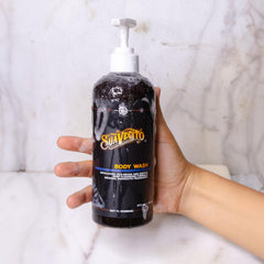 Suavecito bottle held in hand to show 16 oz scale and travel-friendly size