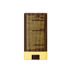 Sun Bum face stick on a beach towel illustrating water-resistant outdoor use