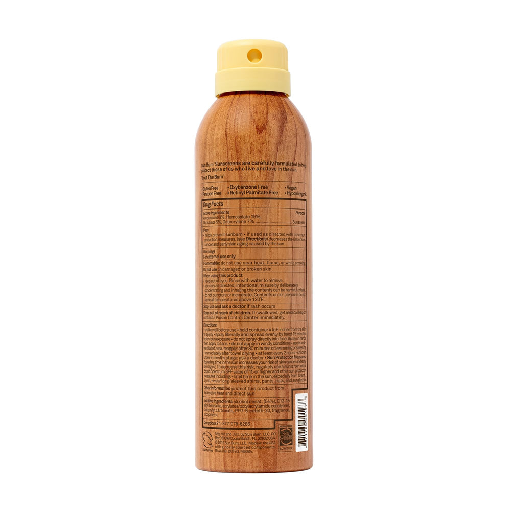 Sun Bum cans staged on beach towel implying travel-ready protection