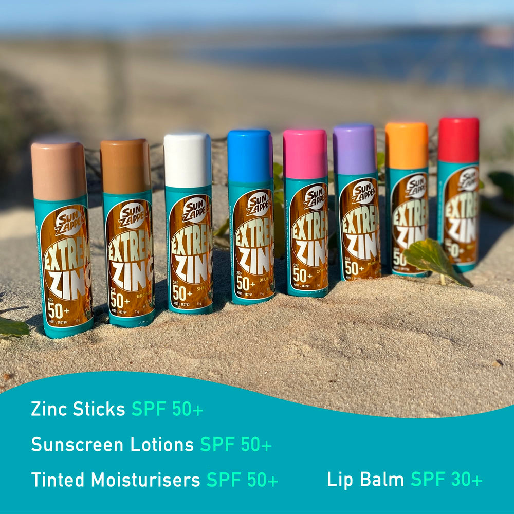 Sun Zapper sticks on beach with surfer showing real-world surf performance and visibility benefit