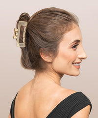Sunolga clip in hand to show size and ease of use for quick styling