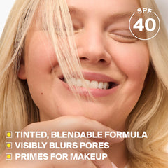 Supergoop! being applied to cheek for shine control and primer effect
