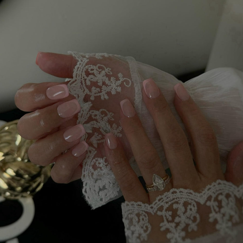 SXVME close-up of white French tip detail highlighting a natural salon finish