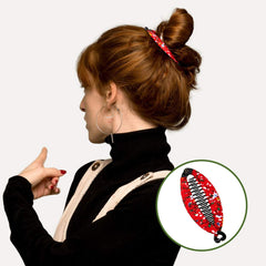 Syhood banana clip next to a hand showing scale and portable travel advantage