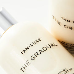 Tan‑Luxe in lifestyle beach setting conveying natural sunless radiance
