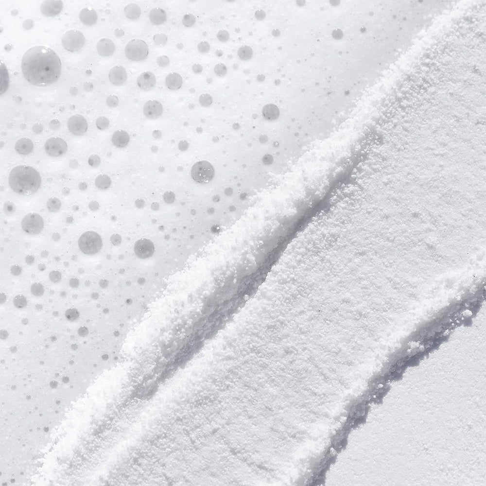 TATCHA powder texture close-up, shows fine rice bran particles for gentle polish