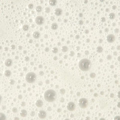 Tea Tree bottle on shower shelf in bathroom setting suggesting invigorating wash