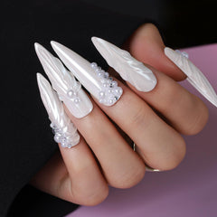 Teenitor nail gems and charms arranged to display rhinestones, pearls, shells and beads