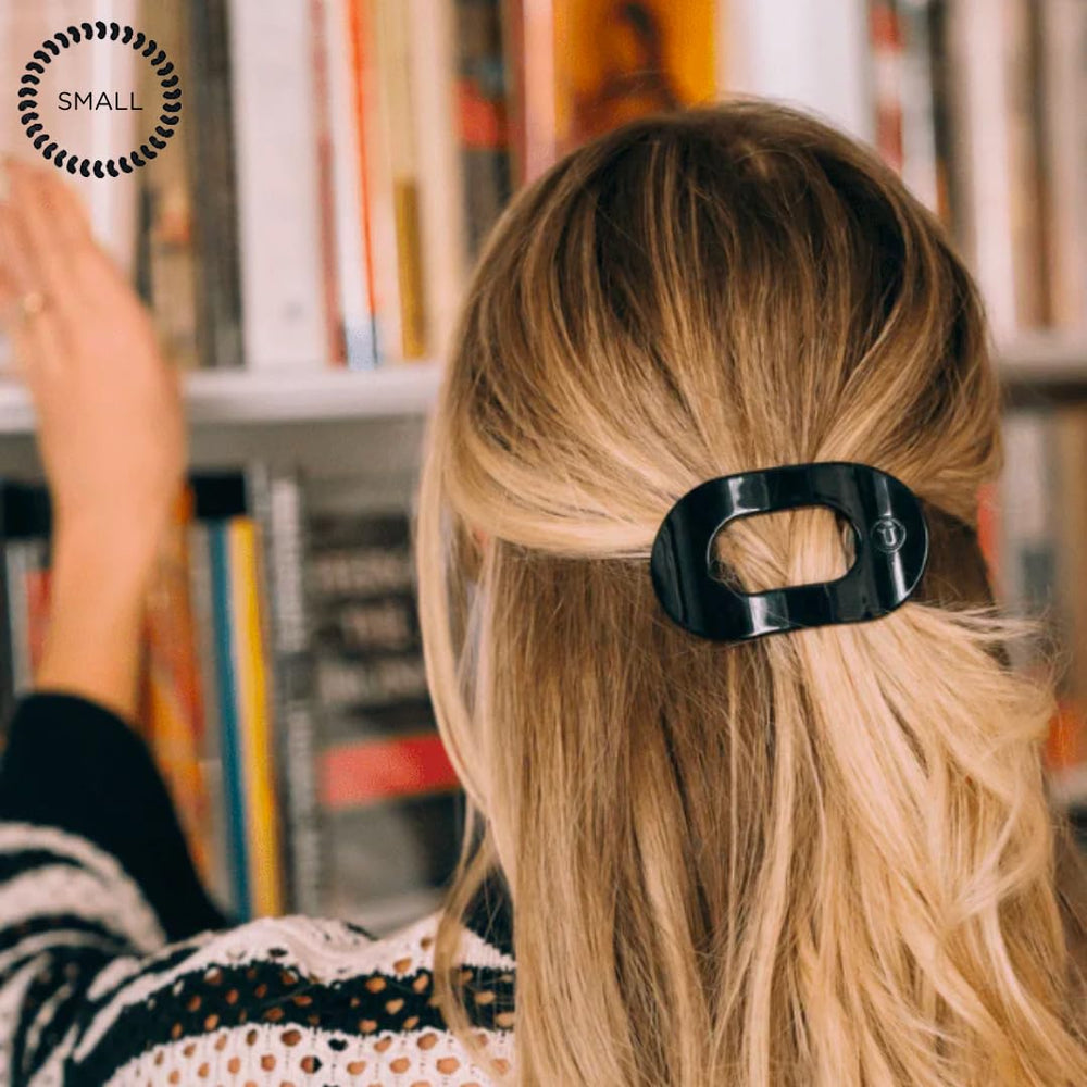 TELETIES small clip in hand to show size and easy travel-friendly convenience