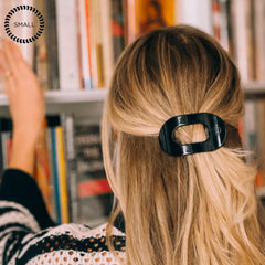 TELETIES small clip in hand to show size and easy travel-friendly convenience