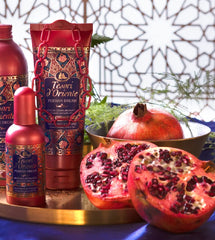 Pomegranate and red tea ingredients with Tesori d'Oriente bottle, highlights fragrance notes
