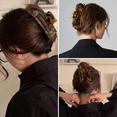 Textention clip securing a low bun, demonstrating reliable all-day hold