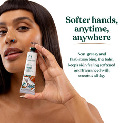 The Body Shop coconut hand balm in a purse for size comparison, travel-ready hydration