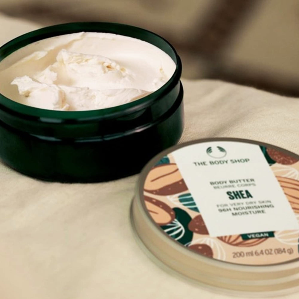 The Body Shop jar in a hand for scale conveying portable, concentrated size