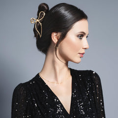The Hair Edit close-up of bow finish highlighting smooth gold texture and polish
