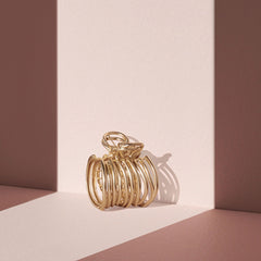 The Hair Edit cuff held in hand showing compact size and lightweight convenience