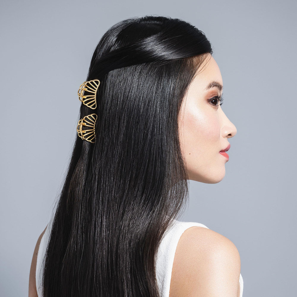 The Hair Edit in-use half-up style secured with a gilded shell clip