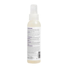The Honest Company 4 fl oz bottle beside a coin indicating travel-friendly size benefit