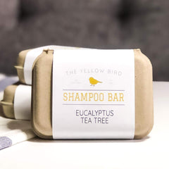 The Yellow Bird shampoo bar on bathroom shelf suggesting sustainable, zero-waste routine