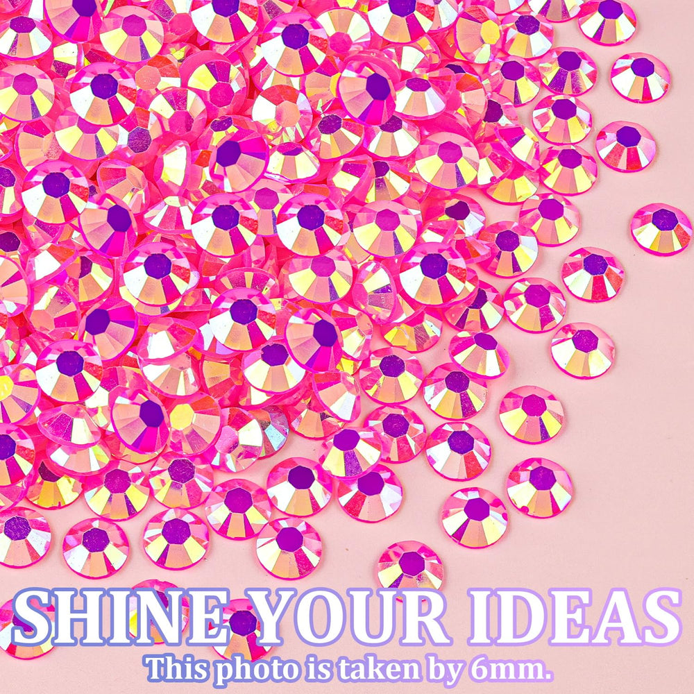 TINKRSTUFF rhinestones held next to a fingertip to show size range and practical scale