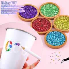 TINKRSTUFF tweezers and pickup pen placed beside gems for precise placement and control
