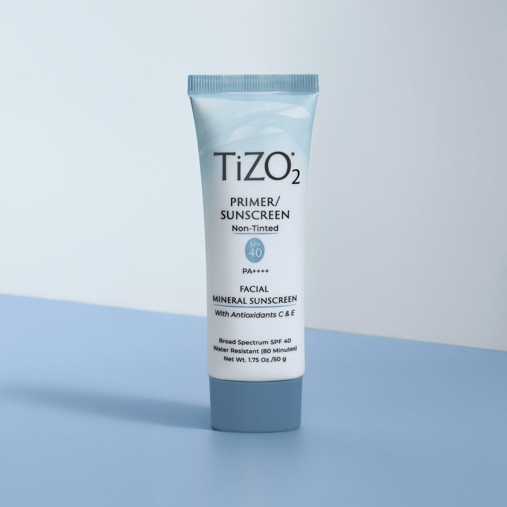 TIZO tube held in hand showing 1.75 oz size for travel convenience