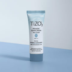 TIZO tube held in hand showing 1.75 oz size for travel convenience
