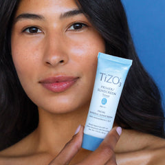 TIZO next to ruler showing 1.75 oz size and travel-friendly benefit
