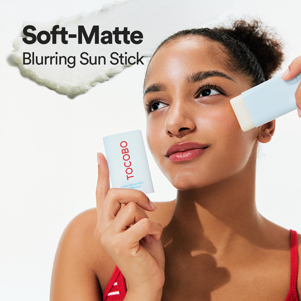 TOCOBO applying sun stick to cheek demonstrating easy no-mess reapplication