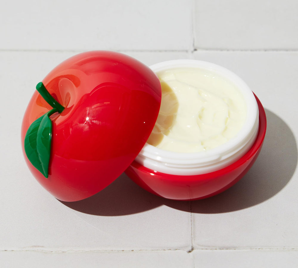 TONYMOLY apple hand cream in hand demonstrating compact travel size and easy application