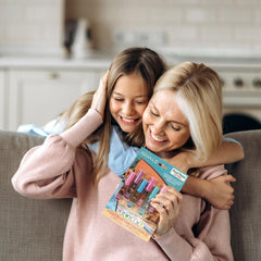 Townley Girl tubes in child's hand demonstrating compact size and simple application