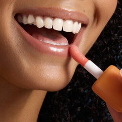 Tree Hut lip oil on lips in use delivering visible shine and softness