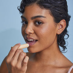 Tree Hut lip scrub stick in hand demonstrating easy mess-free application