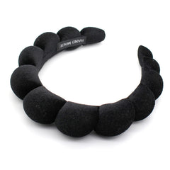 Uchyius headband front view showing sleek velvet finish and elegant style benefit