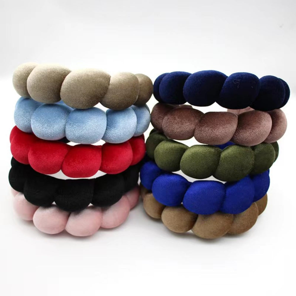 Uchyius headband held in hand showing scale and lightweight convenience