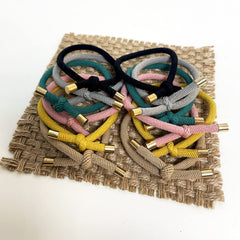 UDeBe hair tie held in hand for size and scale, showing easy portability